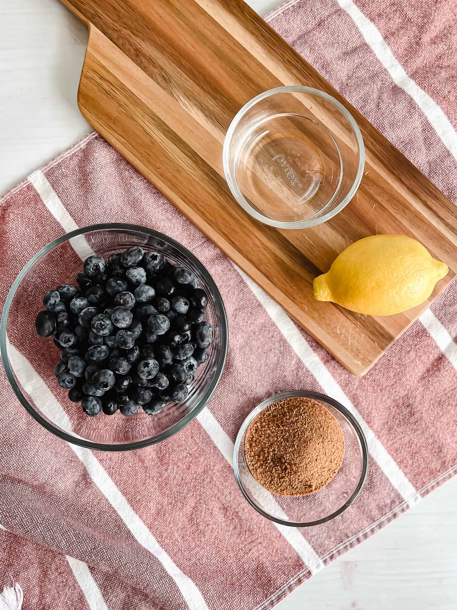 Blueberry lemon compote ingredients displayed over a hand towel. 