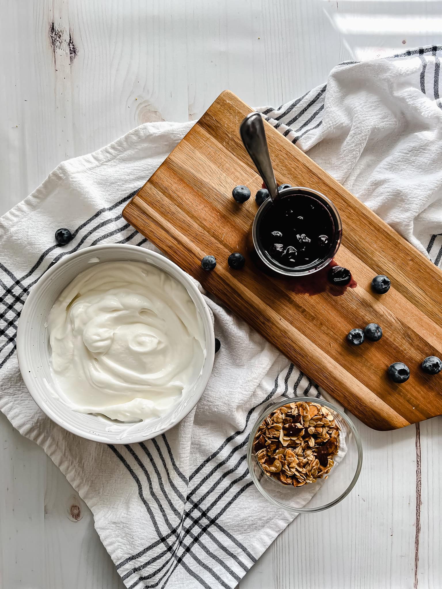 Blueberry parfait ingredients shown on a table. 