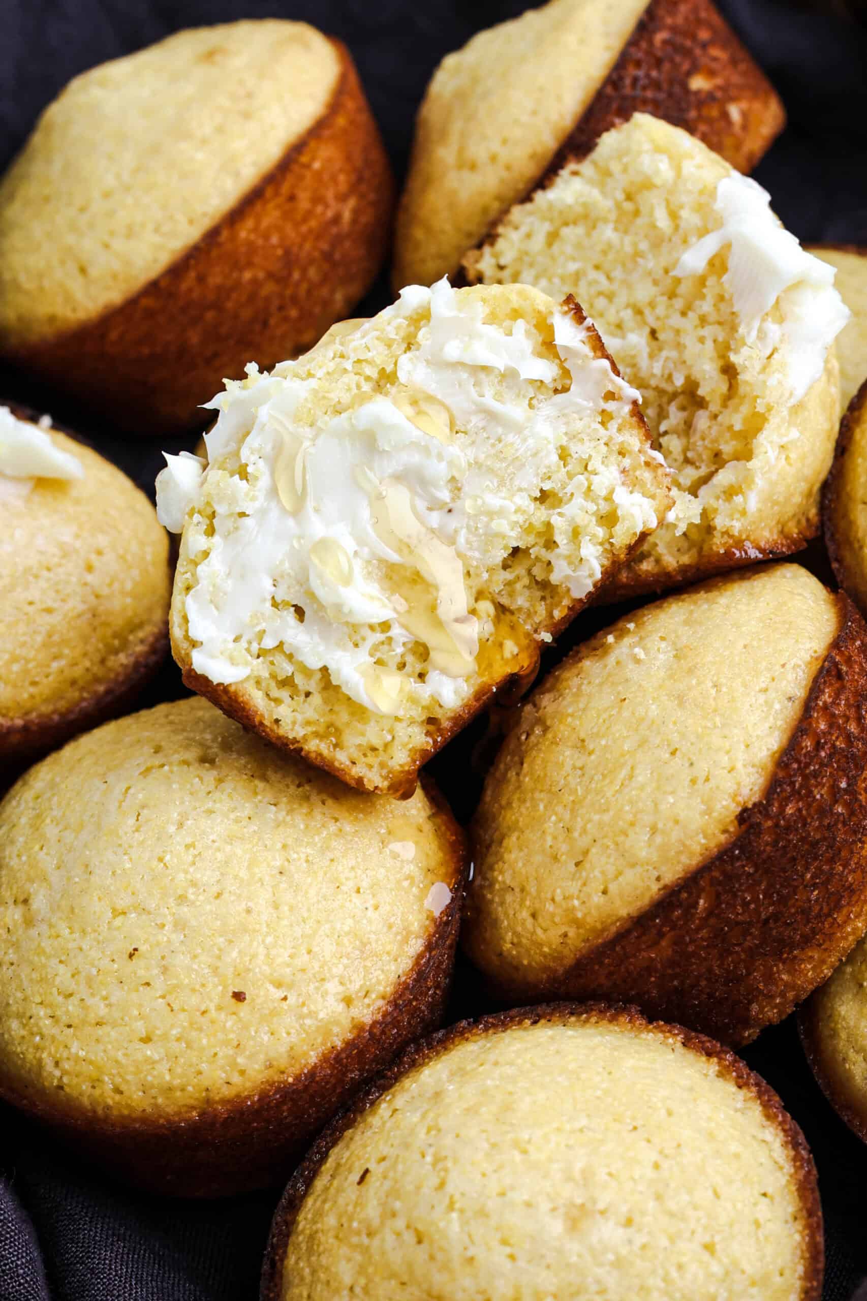 Honey cornbread muffins with butter and honey in a basket